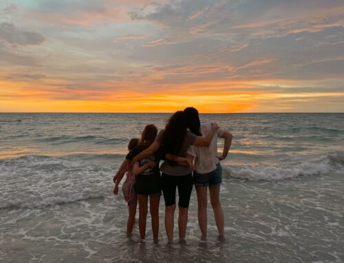 Erin, B2B SaaS content writing strategist, and her family at the ocean.